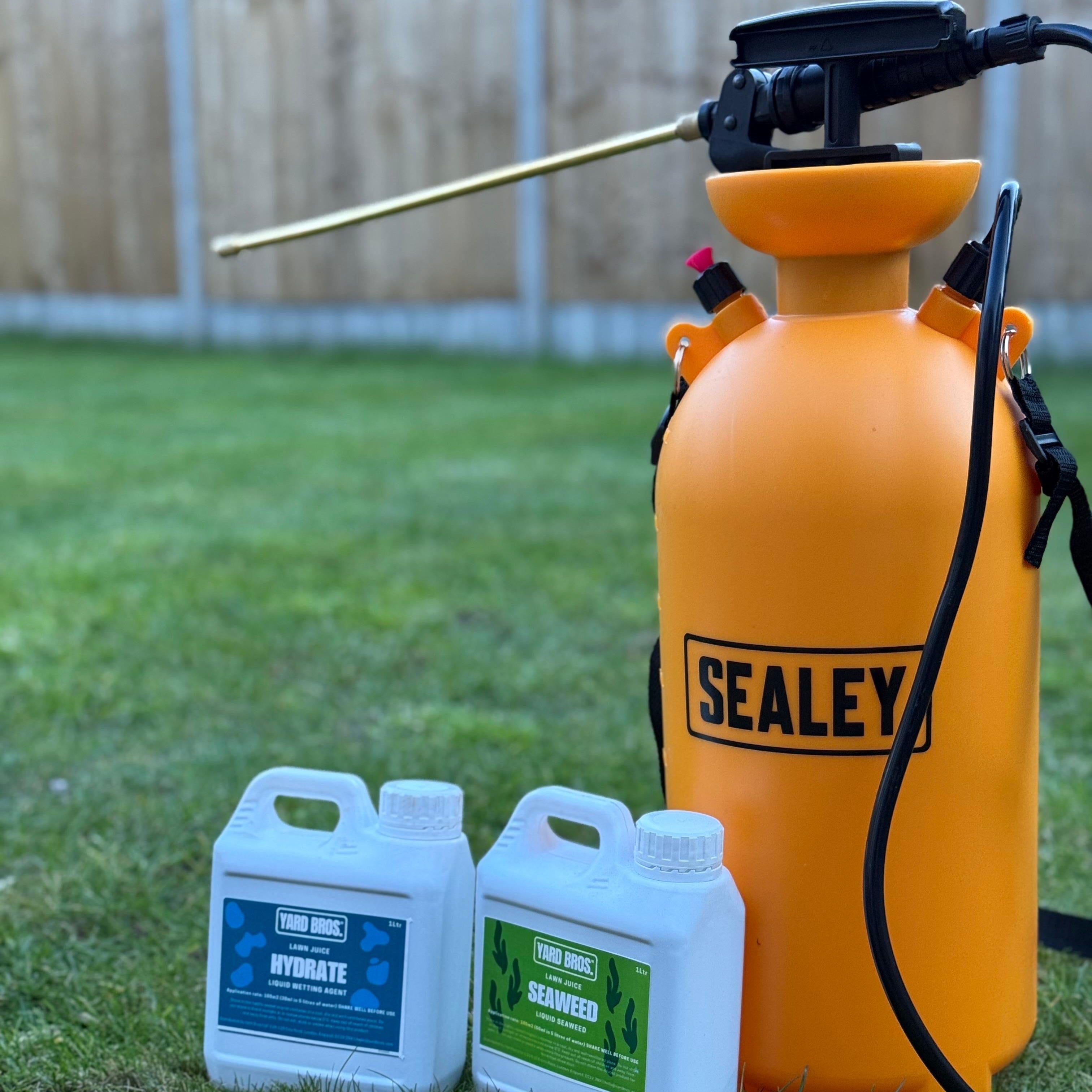Orange Sealey sprayer with two bottles of cleaning products on grass