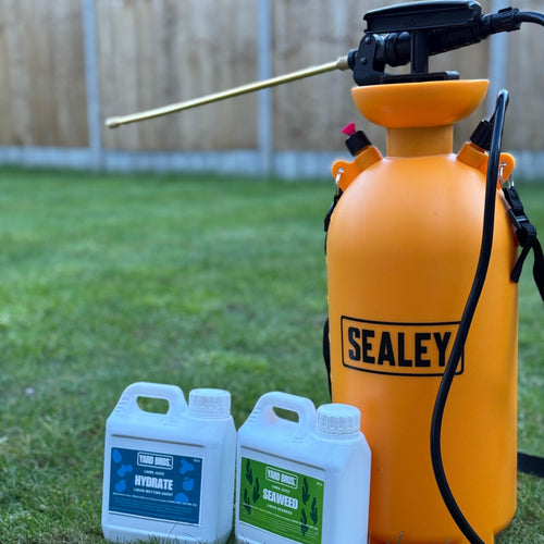 Orange Sealey sprayer with two bottles of cleaning products on grass
